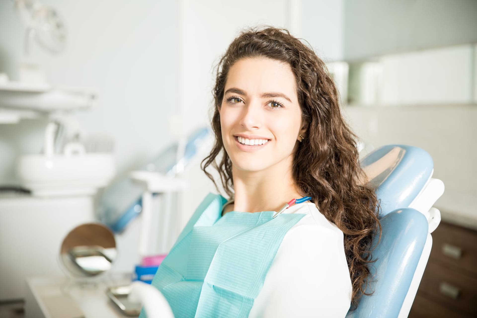 Smiling patient in a dental chair
