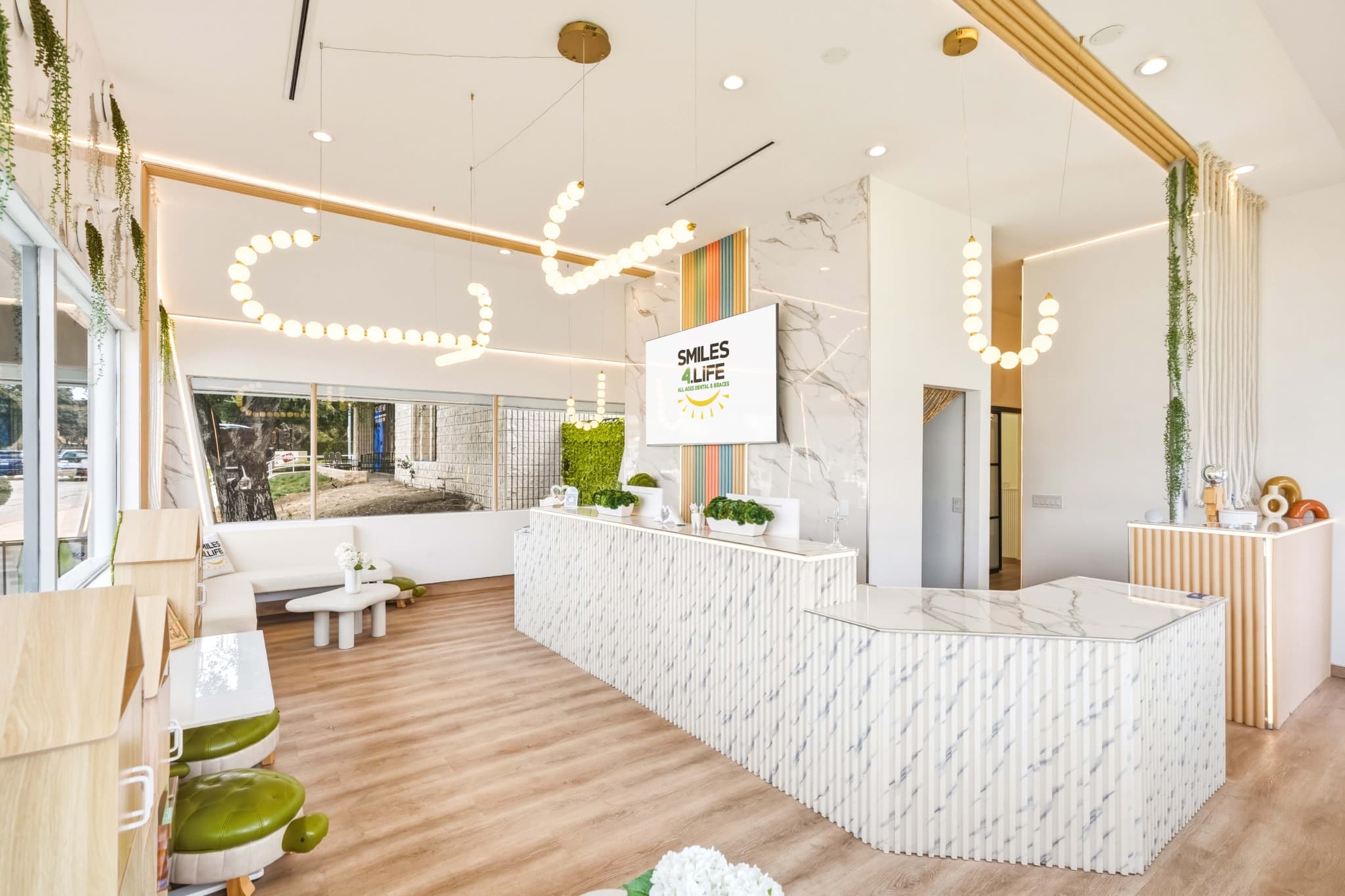 Smiles4Life reception desk with marble front and pendant lights in Thousand Oaks, CA